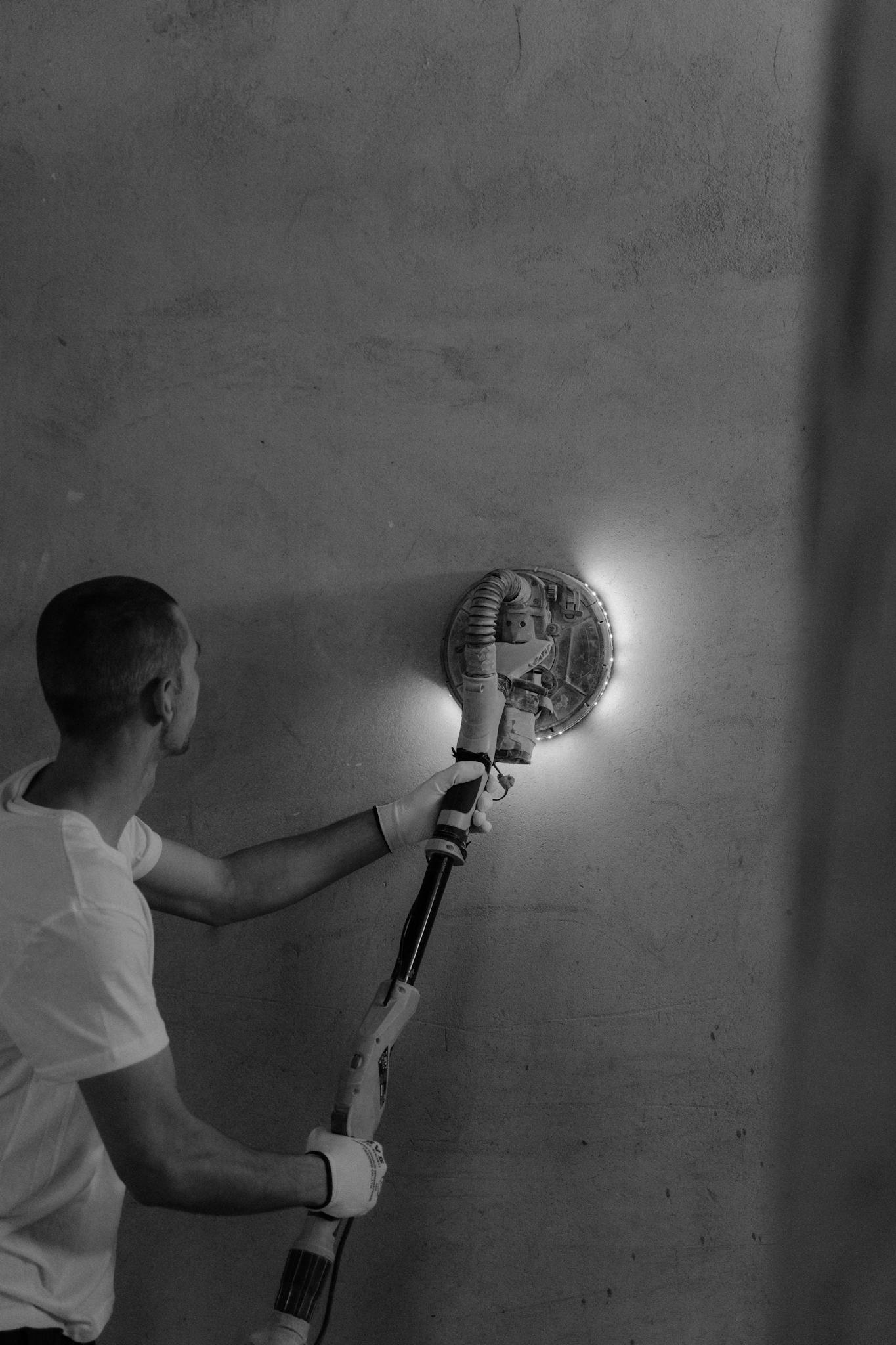 Man Polishing the Wall